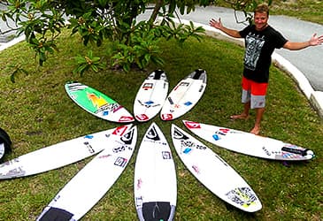 surf-camps image of Ryan Ragan with a ring of boards